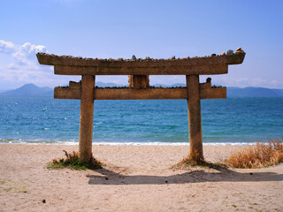 Stone tori gate on the beach at Naoshima in Japan