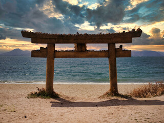 Fototapeta na wymiar Stone tori gate on the beach at Naoshima in Japan