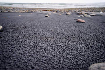 Fototapeta na wymiar Pebble on the black san beach.