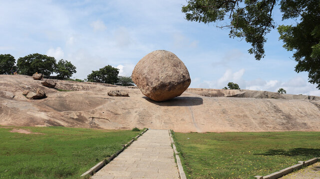 Krishna Butter Ball Large rock and blue sky. A balance rock. Located in the natural background.