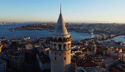 Naklejka premium Aerial view of Galata Tower and the Golden Horn junction with Bosphorus strait in Istanbul, Turkey, during sunset.