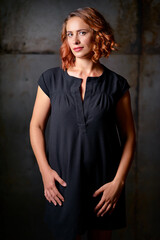 Fototapeta premium Portrait of Beautiful caucasian woman with red hair against black background