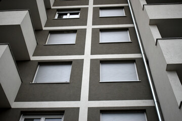 Obraz premium Facade, windows and shutters of the building, new construction.