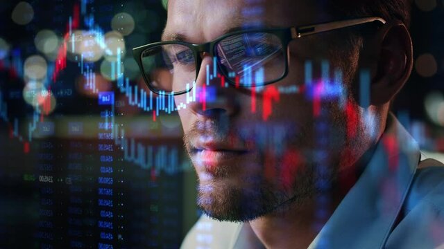 Stock Market Trader Working Investment Charts, Graphs, Ticker, Diagrams Projected on His Face and Reflecting in Glasses. Financial Analyst and Digital Businessman Selling Shorts and Buying Longs