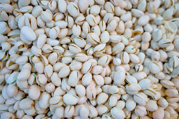 Pistachios for sale on market. Agriculture background. Close-up. Top view.
