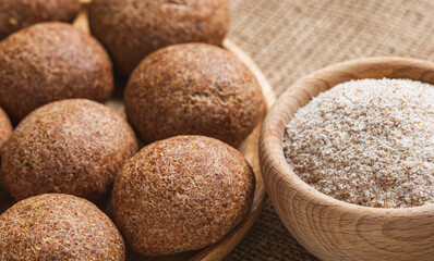 Low carb buns baked with psyllium and seeds. Psyllium in a wooden plate. The keto diet. Healthy food concept