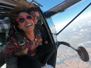 Sky dive tandem. Beautiful happy afro woman.	