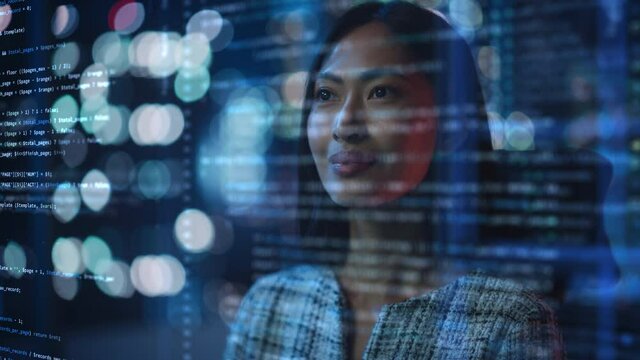 Portrait of Asian Female Startup Digital Entrepreneur Working on Computer, Line of Code Projected on His Face and Reflecting. Software Developer Working on Innovative e-Commerce App using AI, Big Data