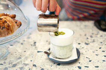 Close up of an unrecognizable waitress making a coffee.