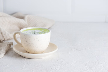 Vegan matcha latte tea with coconut milk in a mug. Horizontal orientation, copy space.