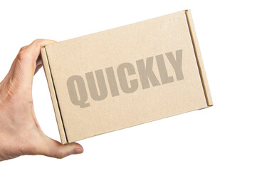 cardboard box in male hand. man holding a parcel. the inscription on the box quickly. the concept of sending parcels