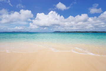 Fototapeta na wymiar Beautiful seascape. Sandy beach with blue clear water.