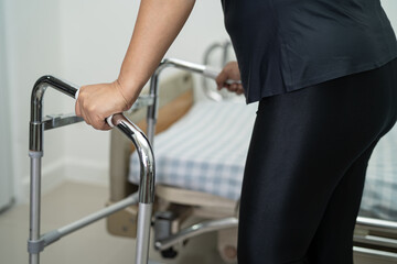 Asian lady patient pain her back, waist, leg and orthopedic lumbar with walker.