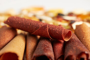 Close up of different colours tasty pastille with berries and delicious almonds, orange, dried apricot, raisins, walnuts, dried apples and kiwi. Concept of healthy assorted dried fruit for snacks.