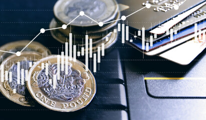 Double exposure of UK Stock graphic with credit card and new pound coin background on financial market trade chart, finance and banking concept. Mixed media. 