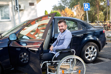 Handicapped young man reaching for his car