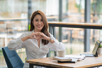 Young beauty healthy happy Black pretty Asian Business women girl smiling and showing with her finger heart figure, sending love to her lover