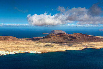 Unique nature and beautiful colorful beaches of volcanic Lanzarote. View of La Graciosa island. Canary islands