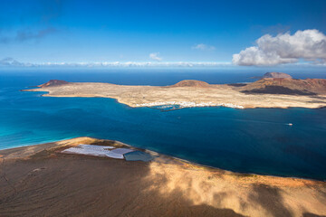 Unique nature and beautiful colorful beaches of volcanic Lanzarote. View of La Graciosa island. Canary islands