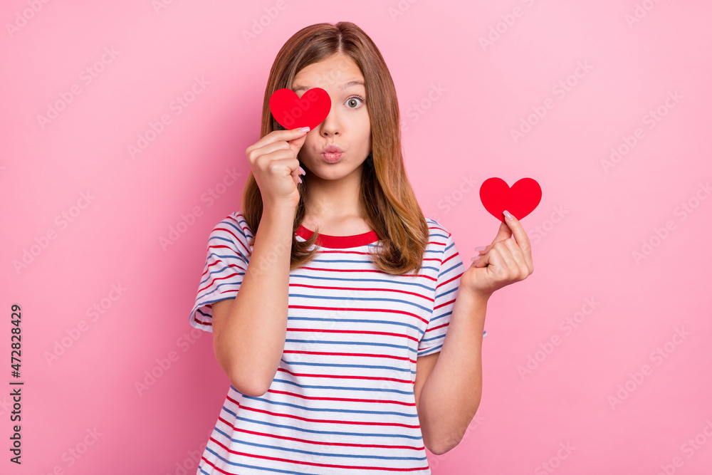 Poster photo of impressed little brown hairdo girl hold heart blow kiss wear striped t-shirt isolated on pi