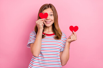 Photo of cute small brown hairdo girl show heart wear striped t-shirt isolated on pink color background