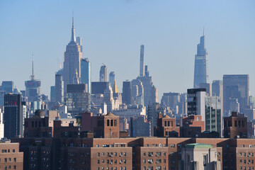 Travel to New York. The amazing skyline of Manhattan with these tall office building skyscrapers during the day. One of the most visited city in America.