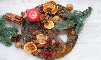 traditional Wiccan altar for Yule sabbath. Wheel of the year, candle, cinnamon sticks, nuts, cones,...