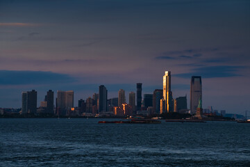 Travel to New York. Sunset over the skyline of Manhattan, one of the most touristic cities in the world. Amazing view to its skyscraper tall office buildings.