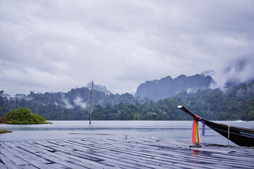 Traditional wooden boats on wharf in Cheow Lan Lake, Khao sok national park, Thailand.