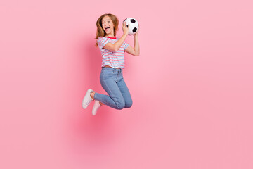 Full body photo of cute teen blond girl jump with ball wear t-shirt jeans shoes isolated on pink...