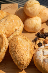 delicious breads served on a wooden board for breakfast at the hotel, approximate photo