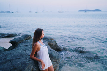Vacation on the seashore.Young beautiful woman with long hair on the  beach.