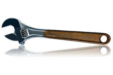 Closeup of a stainless steel adjustable wrench with rusty handle, isolated on white background with reflections.