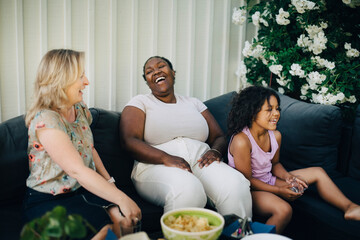 Cheerful mothers laughing during party at backyard