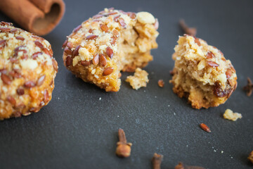 Homemade cookies on black board close up. Crunchy pastry with cinnamon stick. Delicious bakery on black background. Healthy biscuits. Fresh dessert. Tasty sweet food. Homemade meals.