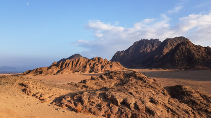 image of the desert and mountains on the Sinai Peninsula at sunset. The Sinai Desert is an attraction accessible to vacationers of all resort areas of Charm.excursion in Egypt. © Natalia