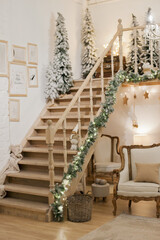 Wooden staircase and cozy living room beautifuly decorated for christmas holidays with christams...