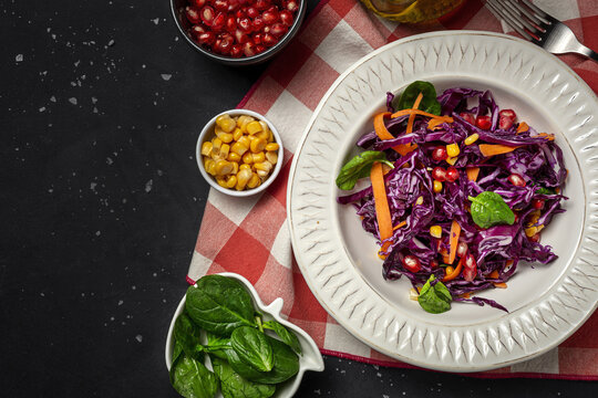 Homemade Purple Cabbage Salad with Corn, Carrots, Pomegranate and Spinach