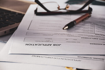 Job application forms on desk. Job search, unemployment concept. Selective focus on the heading.
