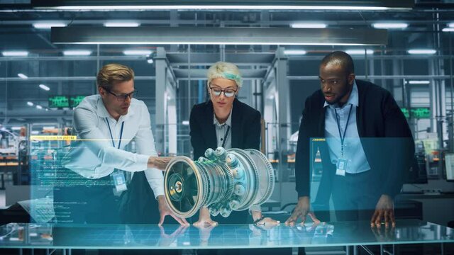 Green Energy Car Design: Diverse Team of Automotive Enginers Using Augmented Reality Hologram to Construct 3D Model of High-Tech Electric Engine Turbine. Futuristic Automated Robot Arm Manufacturing