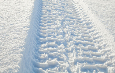 Fototapeta na wymiar Wheel tracks on the snow.