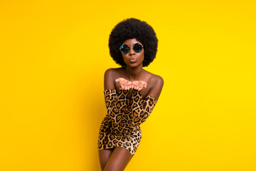Photo of cute sweet dark skin woman dressed leopard outfit glasses sending you arms kiss isolated...