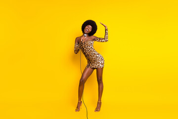 Full length body size photo girl in leopard dress singing smiling overjoyed isolated vivid yellow color background