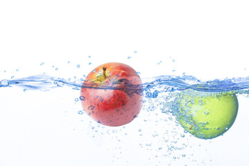 red and green apple in water splash