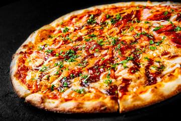 Pizza with chicken and barbeque sauce. Italian pizza on Dark grey black slate background