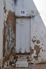 Wooden Entrance Door To Old White Painted Derelict Building with Number '12' 