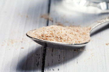 Medicinal Isabgol or psyllium husks with a spoon