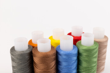 Color sewing threads isolated on white background. Different colors.Bright bobbin thread.