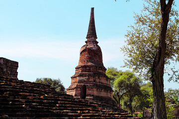 Fototapeta premium Majestic ancient ruins in Wat Mahathat inside the famous heritage site of Ayutthaya Historical Park in Thailand