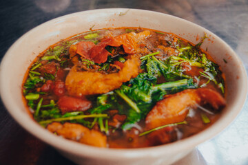 Close up of a bowl of Vietnamese Fried Fish Vermicelli Noodle Soup called Bun Ca